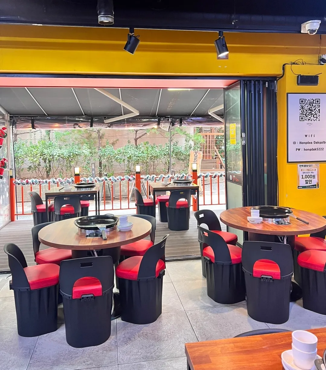 Interior dining area with garden view and traditional Korean grill tables